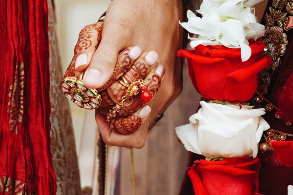 authentic-indian-bride-groom-s-hands-holding-together-traditional-wedding-attire-min