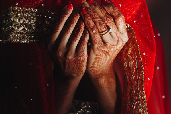 close-up-hindu-bride-s-hands-covered-with-henna-tattoos-min