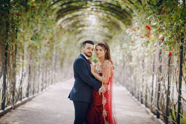 beautiful-woman-long-red-dress-walks-around-city-with-her-husband-min