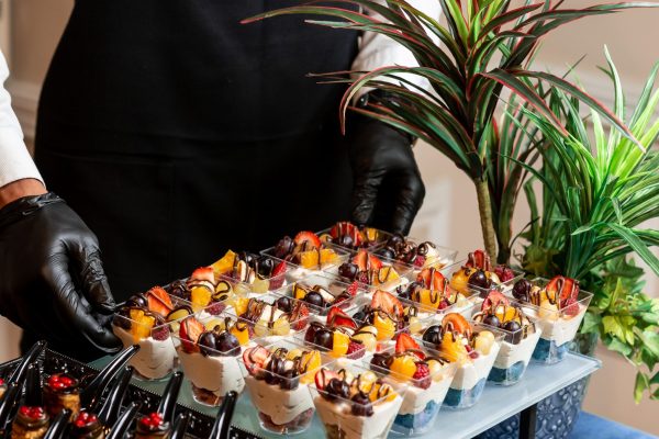 cup-dessert-with-whipped-cream-strawberries-cherries-orange-min