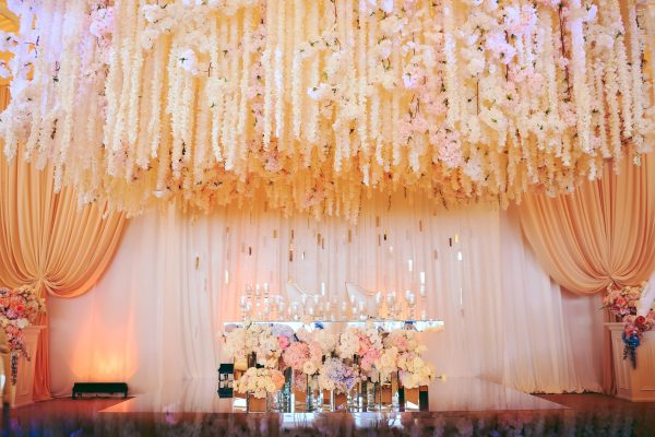 groom-bride-s-wedding-table-decorated-with-flowers-candles-min