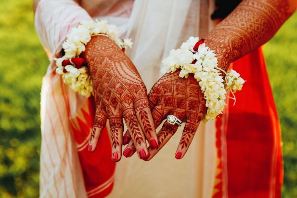 hindu-bride-shows-her-hands-covered-with-henna-tattoos-min