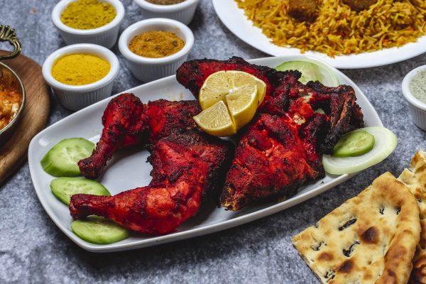 side-view-baked-chicken-with-cucumber-lemon-seasoning-bread-table-min